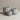 Three gray textured planter pots of different sizes arranged on a neutral beige surface against a matching beige background.