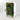 A white modular vertical garden wall unit filled with lush green foliage, including red flowers, set against a seamless light gray studio background.