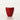 A glossy red fiberglass planter with a wavy, asymmetrical rim, photographed against a seamless white studio background.