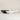 Three ceramic bowls in black, white, and light gray, arranged in a row against a neutral beige background.