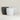 Three minimalist ceramic planters in matte black, matte white, and light gray crackle glaze, arranged on a clean off-white surface against a neutral beige background.